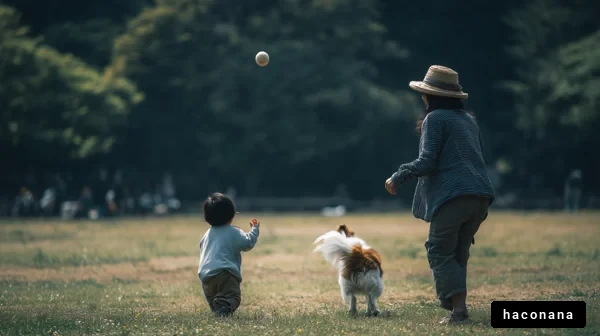 公園で遊ぶ親子と犬