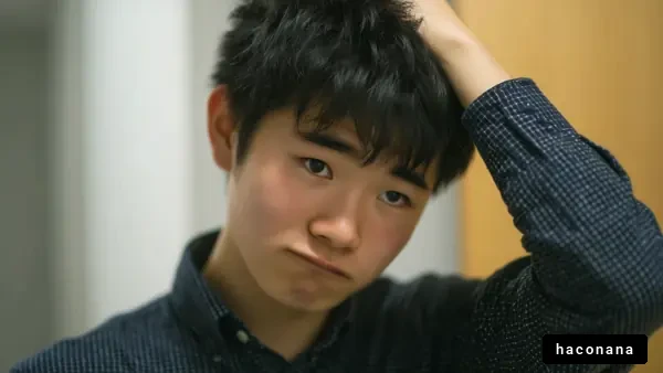 悩む青年の表情